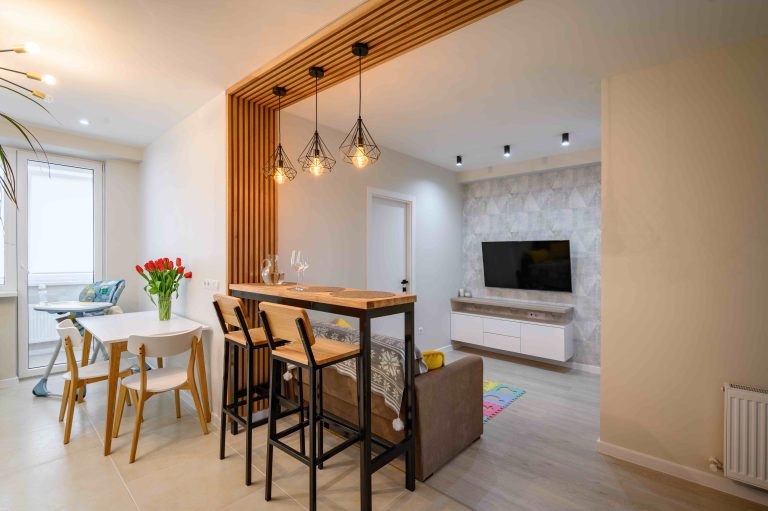 Modern brand new orange, white and teal kitchen interior with dining zone, clean design